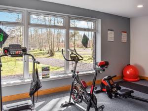 a gym with a bike and exercise equipment next to a window at Saffron in Banchory