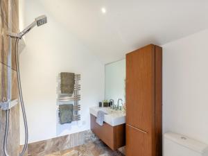a bathroom with a sink and a shower at Midsummer Cottage Retreat in Pilton