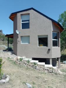 a house that is sitting on top of a field at El Refugio in Córdoba