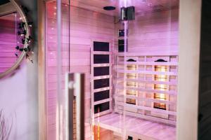 a room with a window with purple lighting at GetAway Penthouse: Spa & Cinema in Echternacherbrück