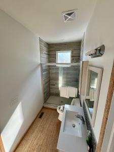 a bathroom with a shower and a sink and a toilet at Ravens End in Dead Man's Flats