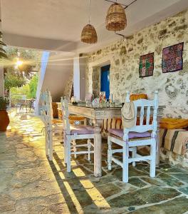 a dining room with a table and chairs at La Maison Bleue in Zaros