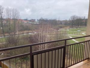 a balcony with a view of a park at Apartament nad rzeką na Mazurach in Olecko