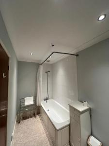 uma casa de banho com uma banheira e um lavatório em The Embassy Hotel em Great Yarmouth