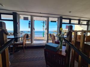 a dining room with a view of the beach at Marina Metro Hotel in Saint Helier Jersey