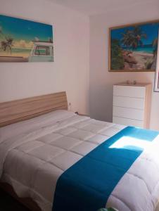 a bedroom with a bed and a painting on the wall at Paraíso de la Costa Brava in Portbou