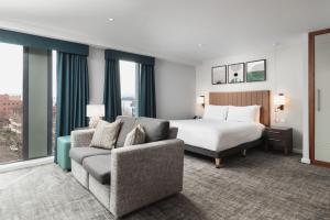 a hotel room with a bed and a couch at Staybridge Suites Newcastle, an IHG Hotel in Newcastle upon Tyne