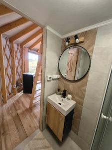 a bathroom with a sink and a mirror at Owcza Jurta in Dursztyn