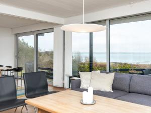 a living room with a couch and a table at Family-Friendly House by the Beach in Ebeltoft