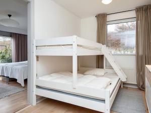 a white bunk bed in a room with a window at Family-Friendly House by the Beach in Ebeltoft