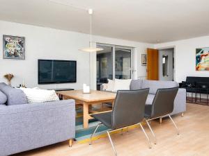 a living room with a couch and a table and chairs at Family-Friendly House by the Beach in Ebeltoft