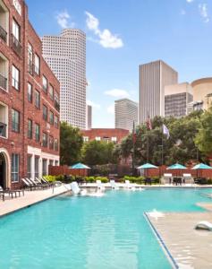 a large swimming pool in the middle of a city at Downtown/Midtown Loft-Pool-Free Parking in Houston