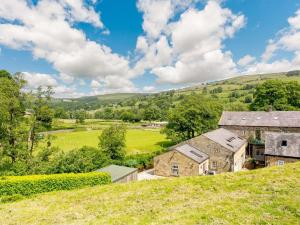 an aerial view of a farm with hills in the background at 1 Bed in Pateley Bridge 88618 in Pateley Bridge