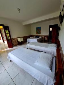 Ein Bett oder Betten in einem Zimmer der Unterkunft Pousada Sol Nascente