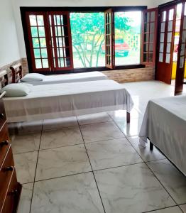 Ein Bett oder Betten in einem Zimmer der Unterkunft Pousada Sol Nascente