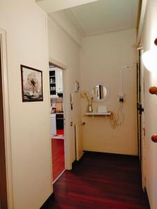 a room with a hallway with a mirror on the wall at Dandelion home Viareggio centro in Viareggio