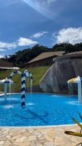 a swimming pool with a water slide in a yard at Hotel Campestre Atibaia in Atibaia