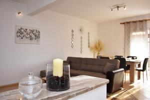 a living room with a couch and a table with a candle at Casa Valesa in Skala Sotiros