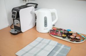 a table with a toaster and a plate of cupcakes at Cozy City Apartments in center K16 in Vienna