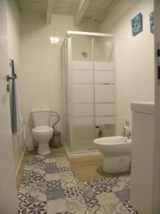 a bathroom with a shower and a toilet and a sink at Casa do Mar in Figueira da Foz