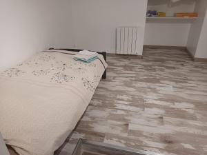 a bedroom with a bed and a tile floor at Appart de charme au bord de l'eau 