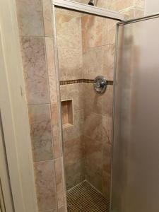 a shower with a glass door in a bathroom at Jasones B&B and Restaurant in Marion