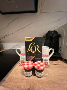 a group of coffee cups and a box on a table at Le zénith vieille ville d'Annecy in Annecy