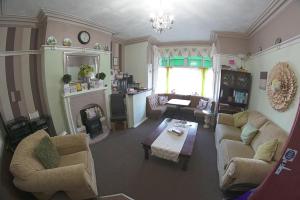 a living room with two couches and a fireplace at The Eastleigh in Skegness