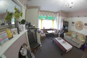 a living room with a couch and a fireplace at The Eastleigh in Skegness