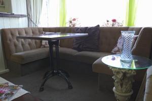 a living room with a couch and a table at The Eastleigh in Skegness