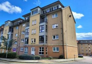 a large apartment building on a city street at Aberdeen Beach 2 Bed Apartment in Aberdeen