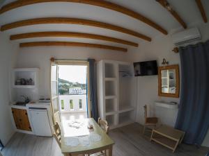 a kitchen and dining room with a table and a window at Blue Bliss in Ambrami