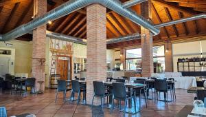 a dining room with tables and chairs in a building at Agriturismo La Camilla in Concorezzo