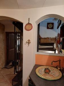 a bathroom with a sink and a mirror at Etnalcantara16 in Castiglione di Sicilia