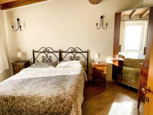 a bedroom with a bed and a window and a mirror at Agriturismo Cervano in Toscolano Maderno