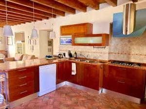 a kitchen with wooden cabinets and a white refrigerator at Agriturismo Cervano in Toscolano Maderno