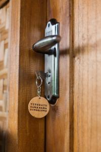 a lock on a door with a tag on it at Tetebatu Sama Sama Bungalows in Tetebatu