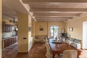 cocina y sala de estar con mesa de madera en Villa Vesuvio, en Boscotrecase