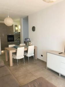 a kitchen and dining room with a table and chairs at Le 2 torri in La Spezia +5 photos