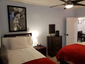 a bedroom with a bed and a dresser with a red blanket at Walk to lifts! Beautiful 2BR at base of PCMR #CondoInPC in Park City +45 photos