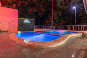 a swimming pool in the middle of a park at night at Villa downtown jarabacoa in Jarabacoa