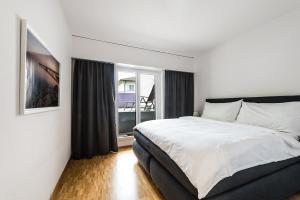 a bedroom with a bed and a large window at Cooldis 1 !Gratis Parken, Free Parking! in Kreuzlingen
