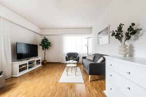 a living room with a couch and a tv at Cooldis 1 !Gratis Parken, Free Parking! in Kreuzlingen