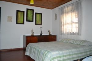 ein weißes Schlafzimmer mit einem Bett und einem Fenster in der Unterkunft Casa Verde Chalet in La Tebaida