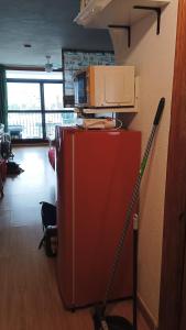 a red refrigerator with a microwave on top of it at Estudio Fenix LOS MOLINILLOS in Roquetas de Mar
