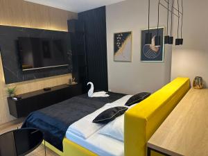 una camera da letto con un letto a cigno sopra di Tauron Arena Apartment with Garage - Kraków Lema a Cracovia