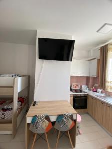 a kitchen with a table and two chairs at Amelia's house in Shëngjin