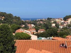 a view of a town with red roofs at Collioure, entre mer, piscine & montagne in Collioure