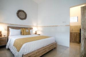 a bedroom with a large bed in a room at The Cozy Haven Sanur in Sanur