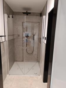 a shower with a glass door in a bathroom at Apartment Sofia in Düsseldorf